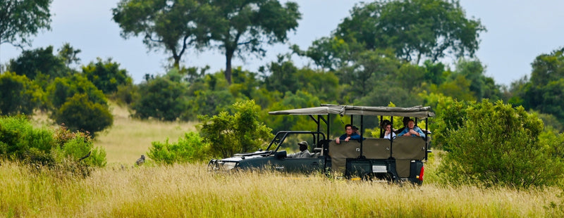 Guided Kenya safari planning game drive vehicle in open savannah for first safari travelers seeking a safari planning guide and practical Kenya travel tips